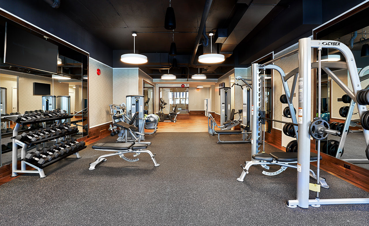 rack of dumbbells and weight machines in the South Park Tower fitness center